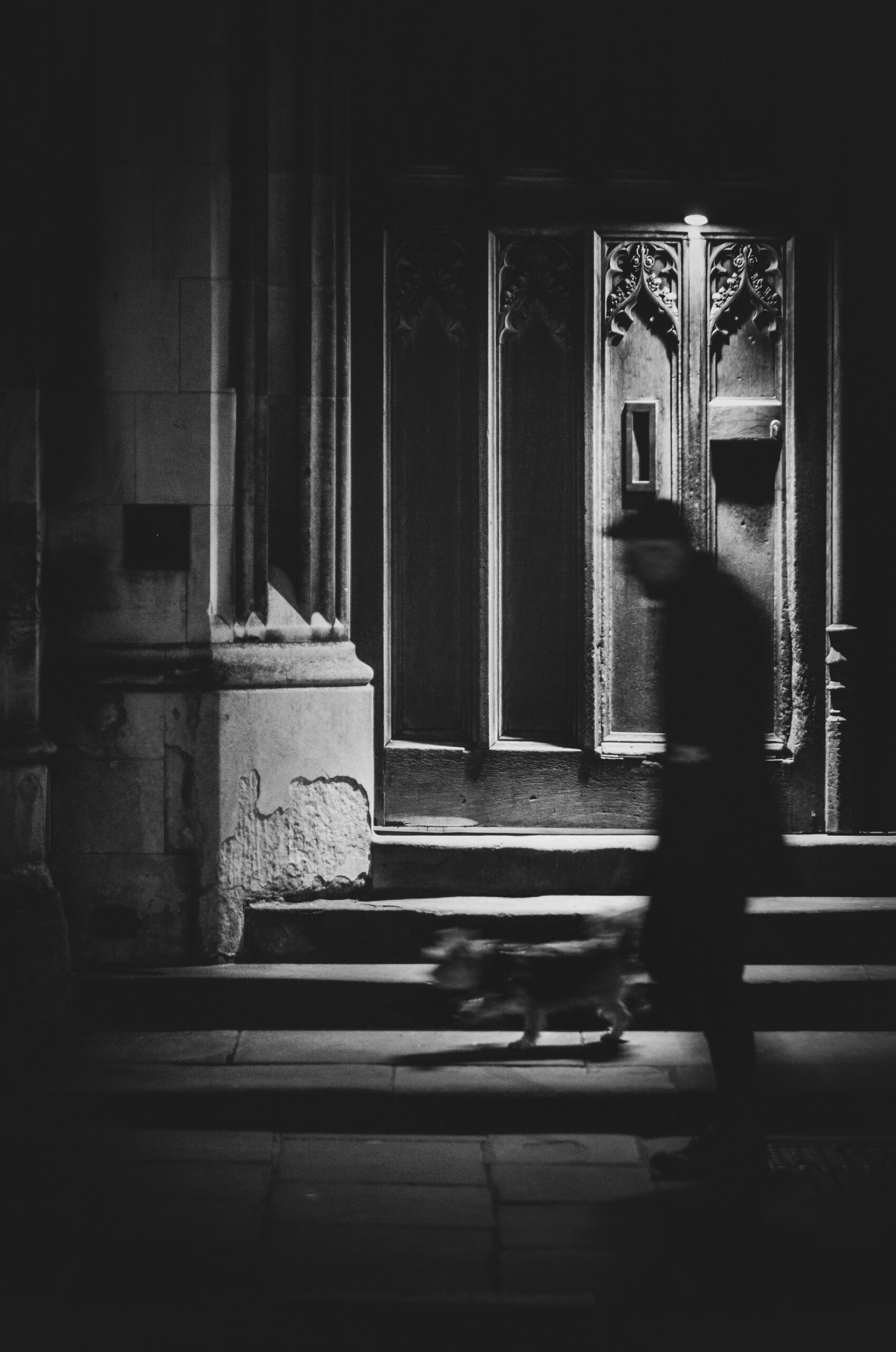 grayscale photo of person sitting on floor